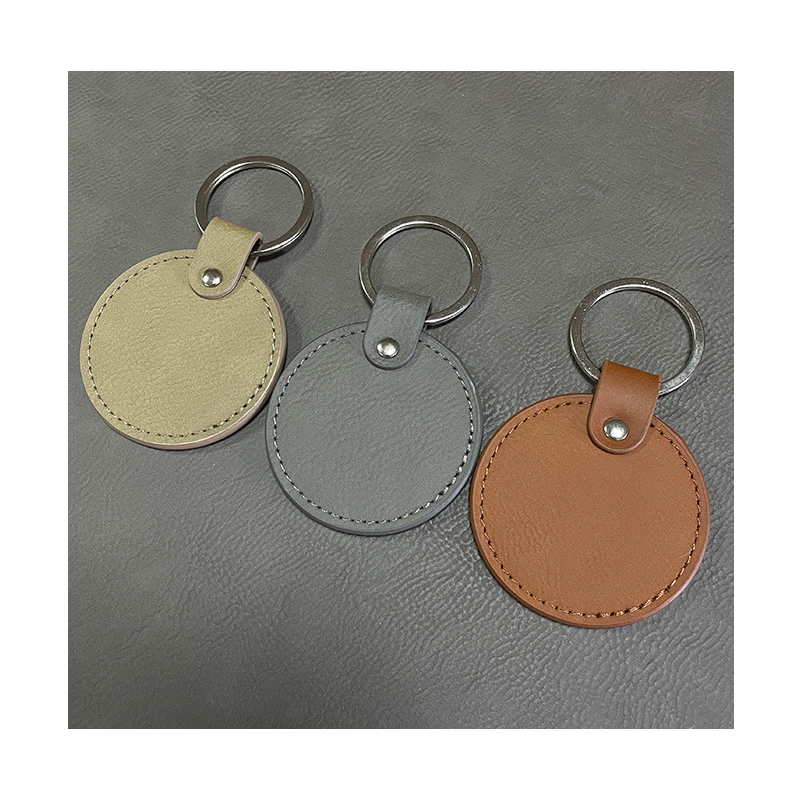 Portachiavi rotondi in similpelle laserabili con bordo oliato Portachiavi rotondi in similpelle laserabili con bordo oliato